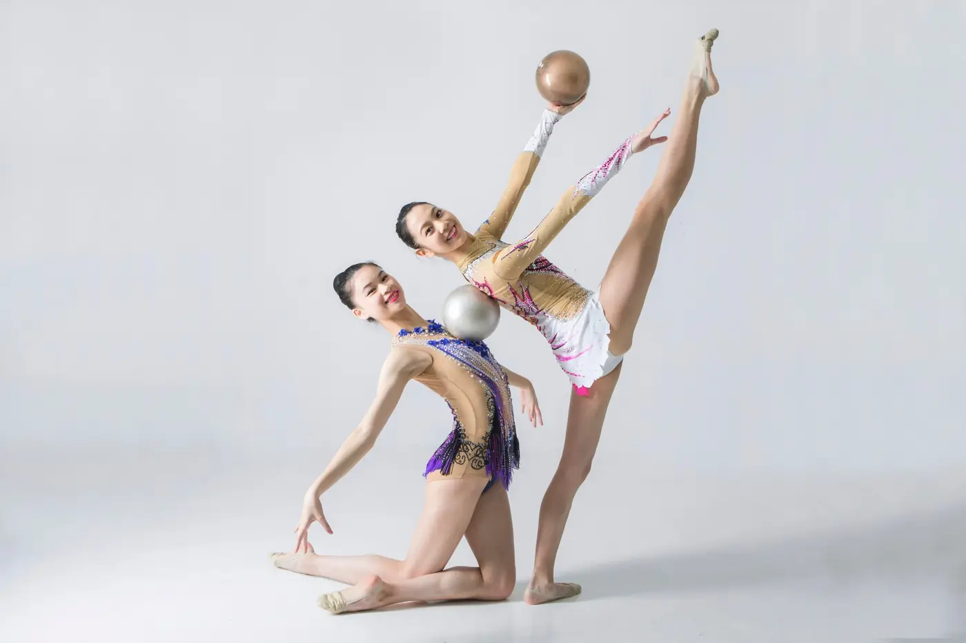 Two gymnasts with balls